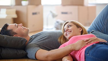 Couple laying on floor in new home