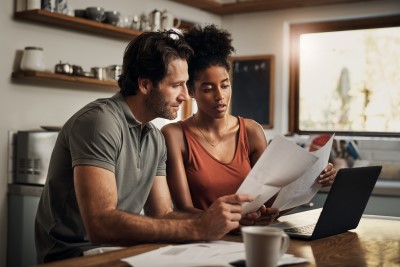 Couple at desk discussing IRA options