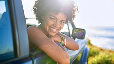 Woman smiling looking out car window