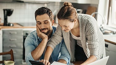 Happy couple working in kitchen