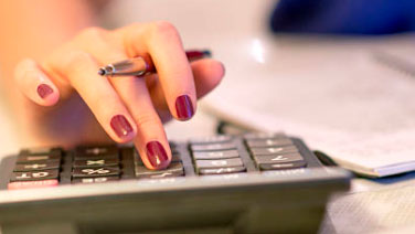 Woman with painted nails using calculator