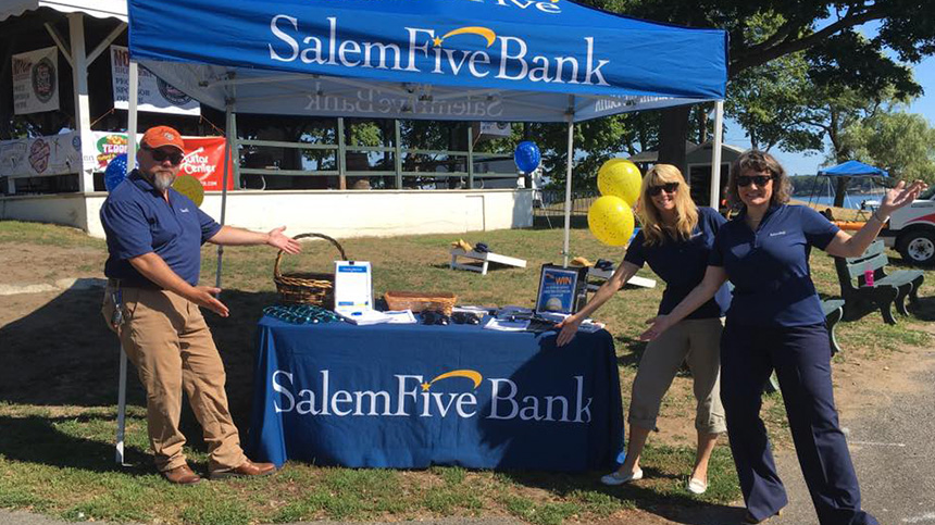 Salem Five employees standing at event table