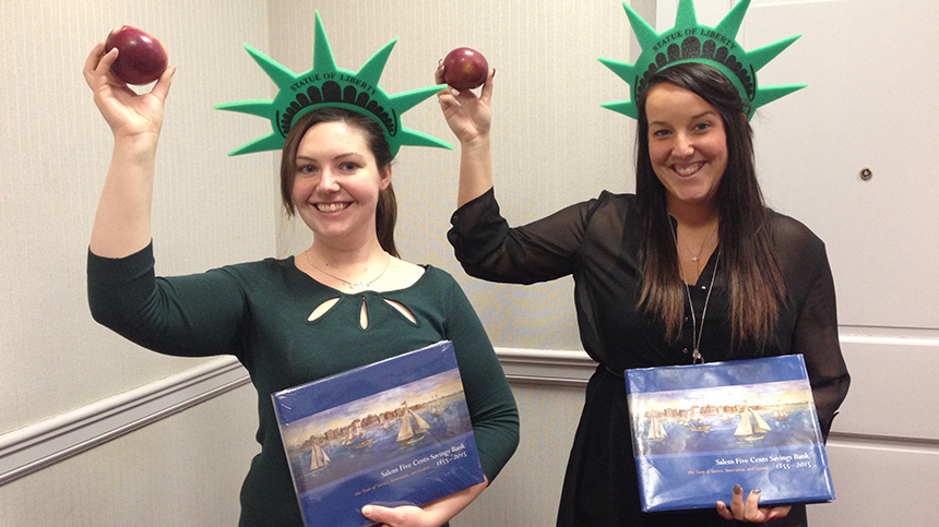 Two Salem Five employees holding apples