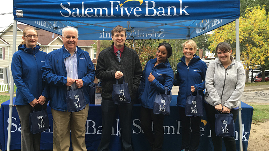 Six Salem Five employees standing under Salem Five event tent