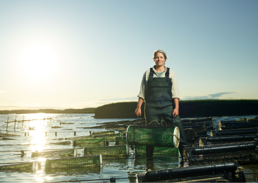 Woman standing in water with traps