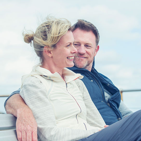 Mature couple sitting by the water